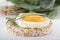 Puffed exploded wheat grains with fried egg and spinach leaves on a light wooden background.