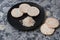 Puffed rice bread slices on black plate on textured background