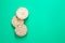 Puffed rice cakes on green background, flat lay, copy space.