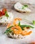 Puffed rice cakes with shrimps and avocado on board. Seafood snack. Crispbread, bread crusts. diet food concept. Basil