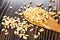 Puffed rice in spoon, scattered puffed rice on wooden table