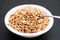 Puffed spelt in white bowl on ceramic background