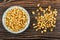 Puffed wheat in blue saucer, scattered wheat on table. Top view