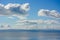 Puffy cumulous clouds billowing across a blue sky