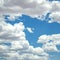 Puffy cumulus clouds on dazzling blue sky