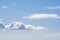 Puffy White Clouds Against a Pastel Blue Sky