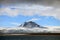 Puffy white clouds, blue sky, mountain peaks and glaciers in the arctic Svalbard