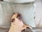 Pug dog having a siesta an resting in bed on the pillow on his back , tongue sticking out looking very funny