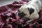 Pug dog lying on a plaid blanket