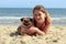 Pug Dog and owner on a sunny beach