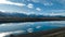 The Pukaki hydro power scheme canal in rural Twizel running in parallel with the snow capped Ben Ohau mountain range