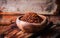 Pul biber - crushed red chili pepper in vintage bowl on wooden background. Selective focus. Toned image. Turkish cuisine