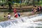 PULHAPANZAK, HONDURAS - APRIL 18, 2016: People are bathing in a river above Pulhapanzak waterfal