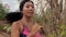 Pull back gimbal shot in dolly style of young exotic fit and beautiful Asian Indonesian woman running on trail road jogging