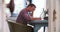 Pull Focus Shot Of Man In Home Office Through Doorway