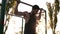 Pull-up strength training exercise - fitness man working out his arm muscles on outdoor gym doing chin-ups pull-ups as