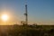 Pulling equipment in oil field at sunset