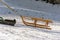 Pulling wooden sled uphill on a sunny winter day