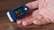 Pulse Oximeter Measures Pulse and Oxygen Saturation on a Male Finger Close-Up