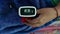 A pulse oximeter on a persons finger measures the oxygen level in the blood rate at home COVID-19 health technology