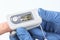 Pulse oximeter shows normal blood oxygen saturation level during  checking coronavirus symptoms