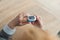 Pulse Oxymeter on a woman finger hand on a wooden table. Top view.