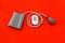 Pulsimeter on the desk of the doctor for diagnostics of cardiac disease on red background top view space for text