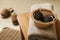Pumice stones in wicker basket and towel on table indoors. Space for text