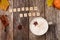 Pumkin latte coffee wooden blocks words on rustic wood background , coffee, pumpkins and autumn leaves