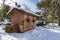 Pump house and water well in OÂ´Donnel park in Alcala de Henares on a sunny day after a snowfall