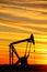 Pump jack in the oil field at sunset