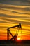 Pump jack in the oil field at sunset