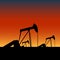 Pump jacks on oil wells at sunset