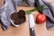 Pumpernickel in a glass bowl on a wooden board with knife and to