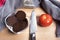 Pumpernickel in a glass bowl on a wooden board with knife and to