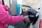 Pumping petrol at gas station into vehicle.hand using a fuel nozzle at a gas station.Petrol Gasoline in Cold weather Safe drive