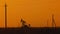 Pumping petroleum Rig in desert at sunset. Oil industry. Pump Jack Extracting Crude Oil from a Oil Well. Fossil Fuel