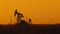 Pumping petroleum Rig in desert at sunset. Oil industry. Pump Jack Extracting Crude Oil from a Oil Well. Fossil Fuel