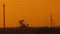 Pumping petroleum Rig in desert at sunset. Oil industry. Pump Jack Extracting Crude Oil from a Oil Well. Fossil Fuel