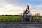 Pumpjack, engineer and agricultural field during twilight time