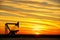 Pumpjack in the oil field at sunset