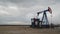 Pumpjack Oil Pump operating on natural gas in the field pumping from the oil well