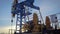 Pumpjack on an oil well in winter forest in daytime, extraction of petroleum in northern countries