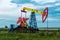 Pumpjack operating at an oil well in field outdoors
