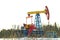 A pumpjack over an oil well in a winter wooded landscape