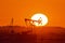 Pumpjack on sunset background. A pumpjack is the overground drive for a reciprocating piston pump in an oil well.