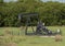 Pumpjack surrounded by hay bales in the State of Oklahoma in the United States of America.