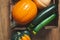 Pumpkin, acorn squash, butternut squash, and zucchini close up , wooden background, top view.
