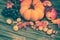Pumpkin, apple, nuts, grapes on wooden background