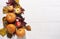 Pumpkin, apples, dry leaves, wild grapes lie on a white wooden background. Autumn composition, halloween, thanksgiving concept,